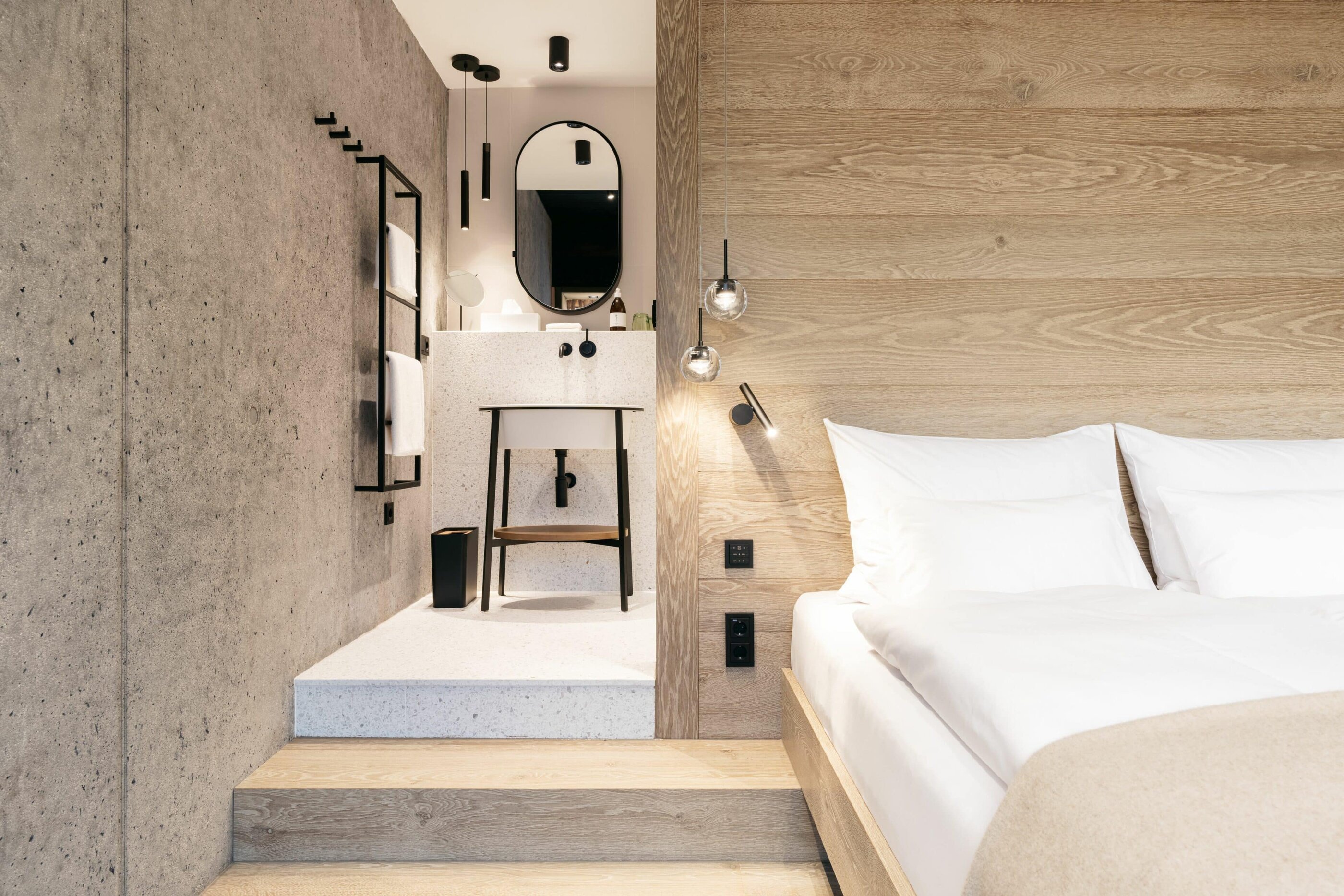 Bett und Badezimmer im Doppelzimmer des Refugium Lunz