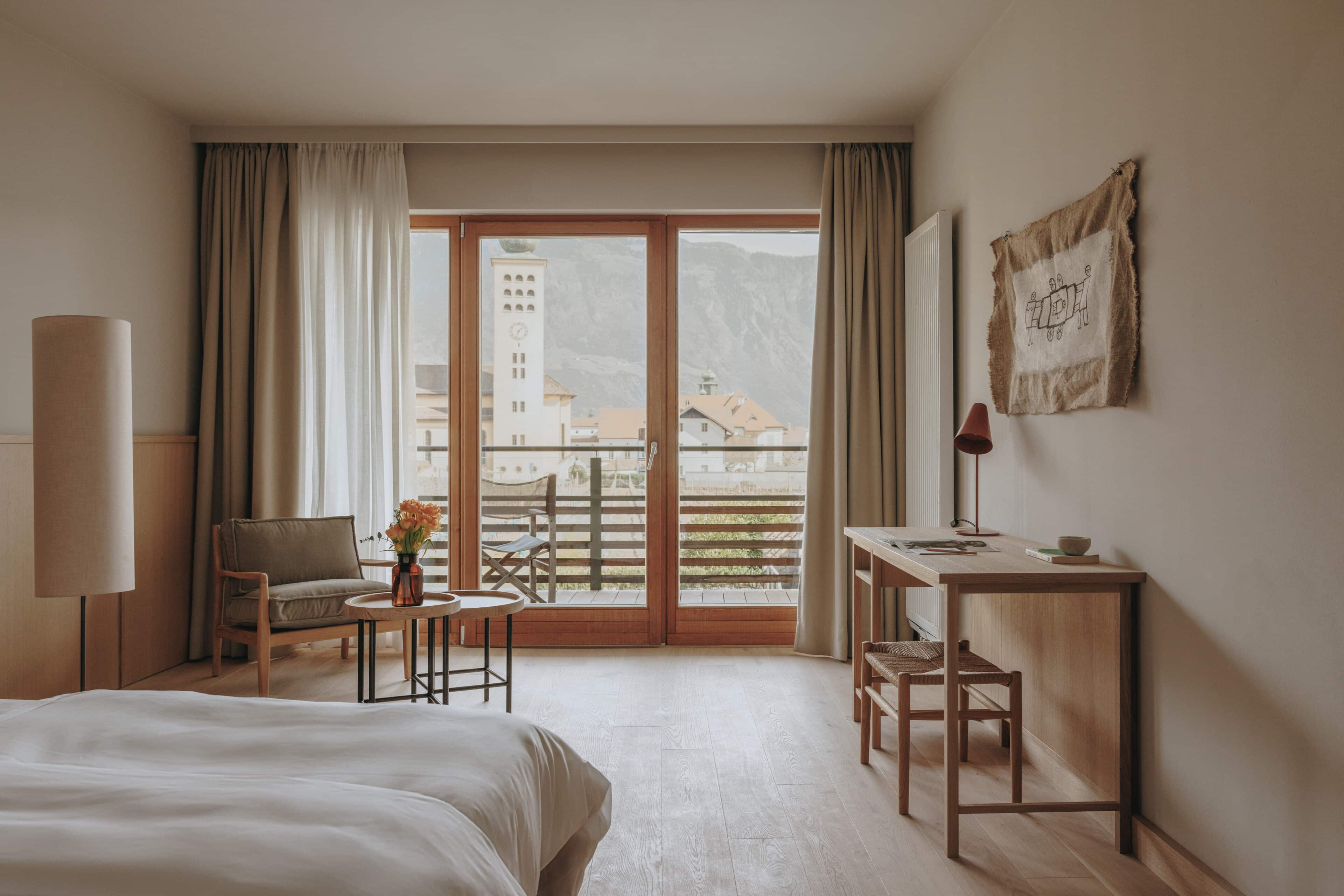 Doppelzimmer mit großer Fensterfront und Ausblick auf die Berge im Hotel Schwarzschmied