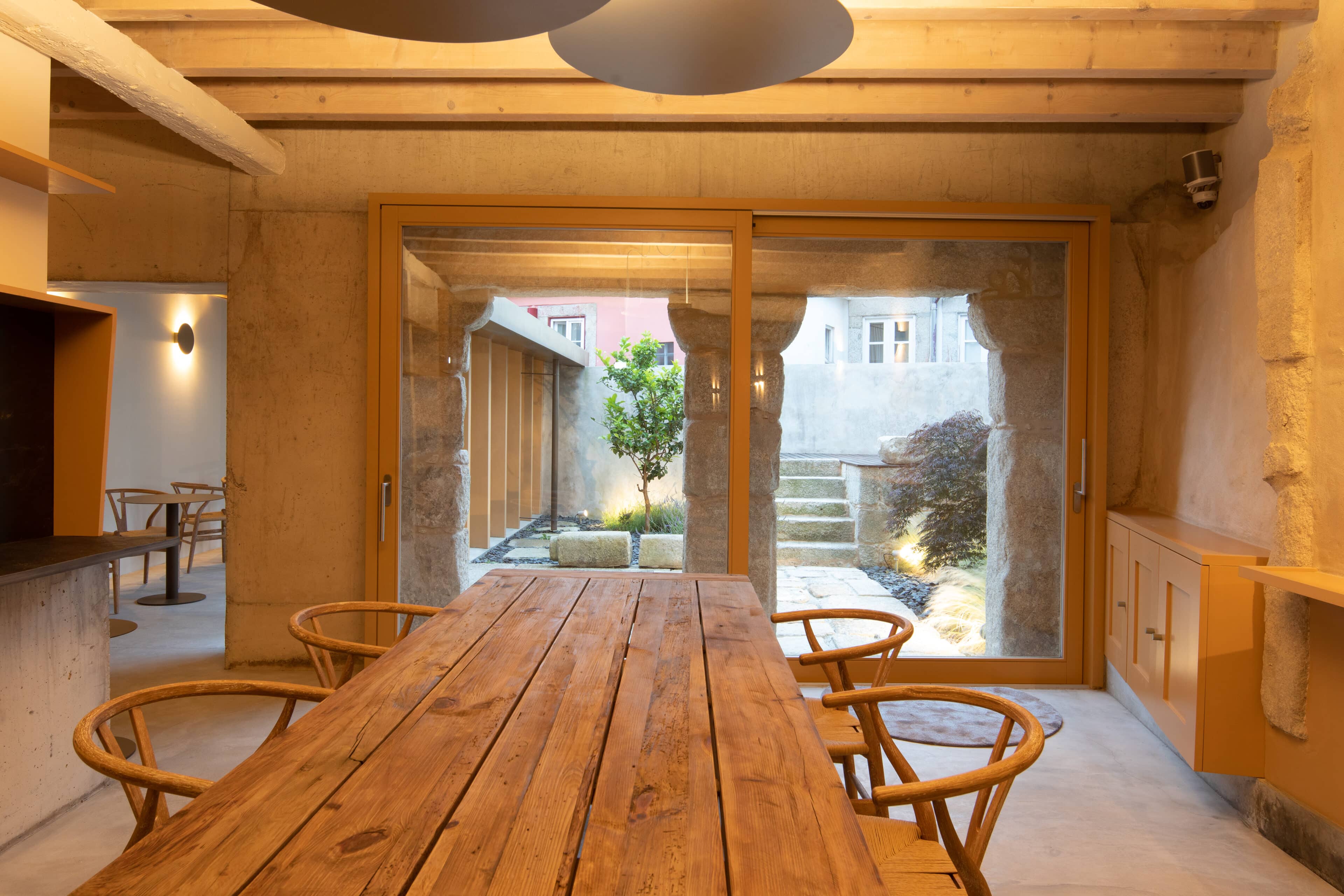 großer Holztisch im Gastraum des Hotel Na Travessa Suites