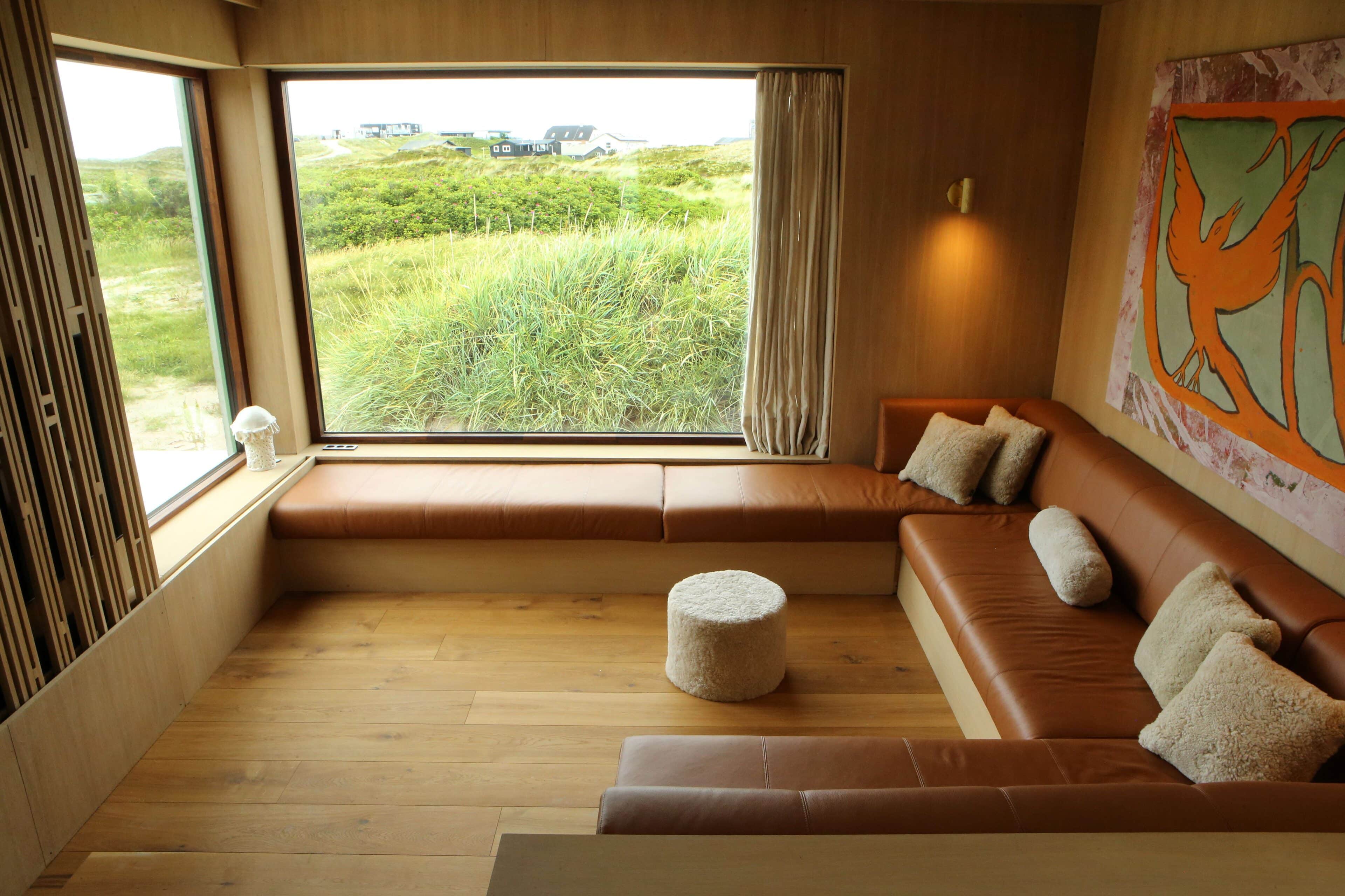 Wohnzimmer mit großer Couch und Panoramafenster