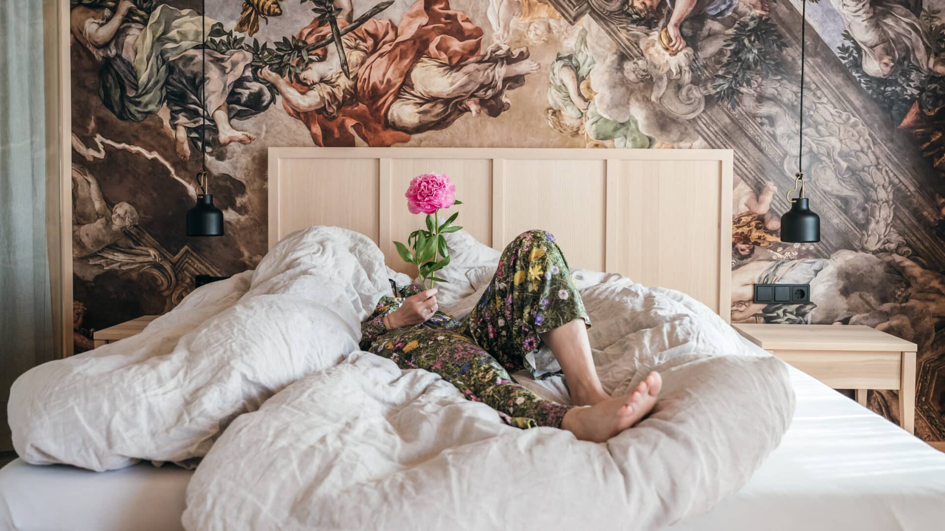 Gast im Bett mit Blume im Halwina Hideaway